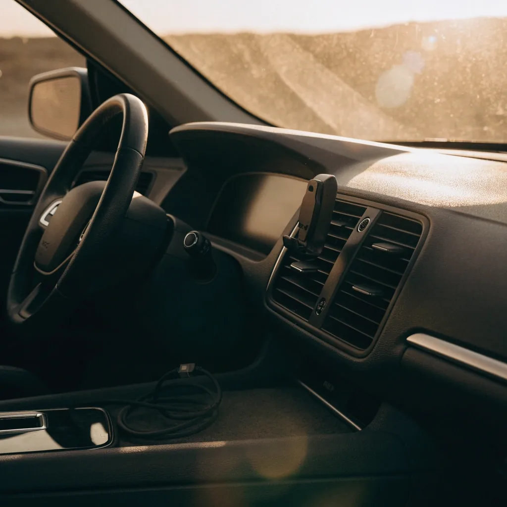 Matte dashboard phone mounts photographed unlit in warm sidelight