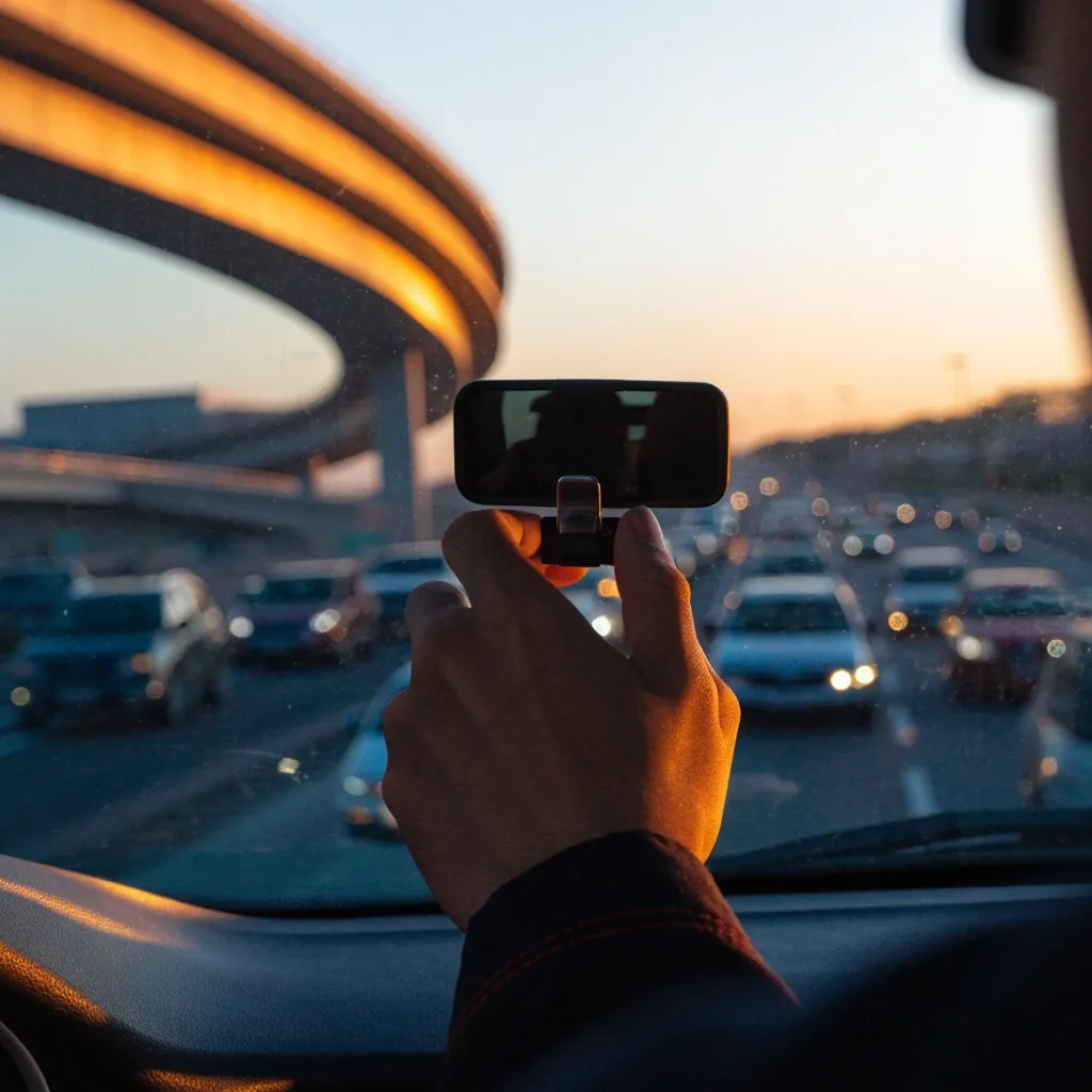 Driver's view across slow-moving traffic on a crowded UAE motorway at golden hour